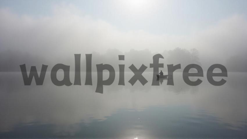 Foggy Lake with Fisherman in Boat