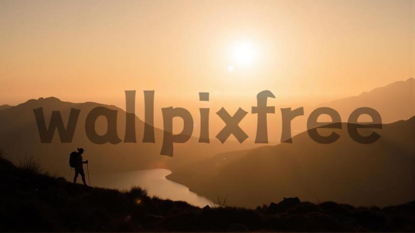 Hiker Silhouette at Sunset Over Mountains